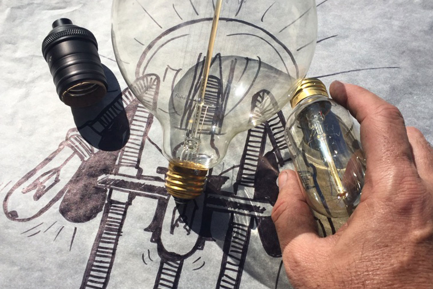 DCLA FAB engineering and fabrication process with glass components over CAD drawing during project development