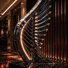 inished architectural metal sculpture installation inside a modern interior environment featuring illuminated structural fabrication and engineered assembly.